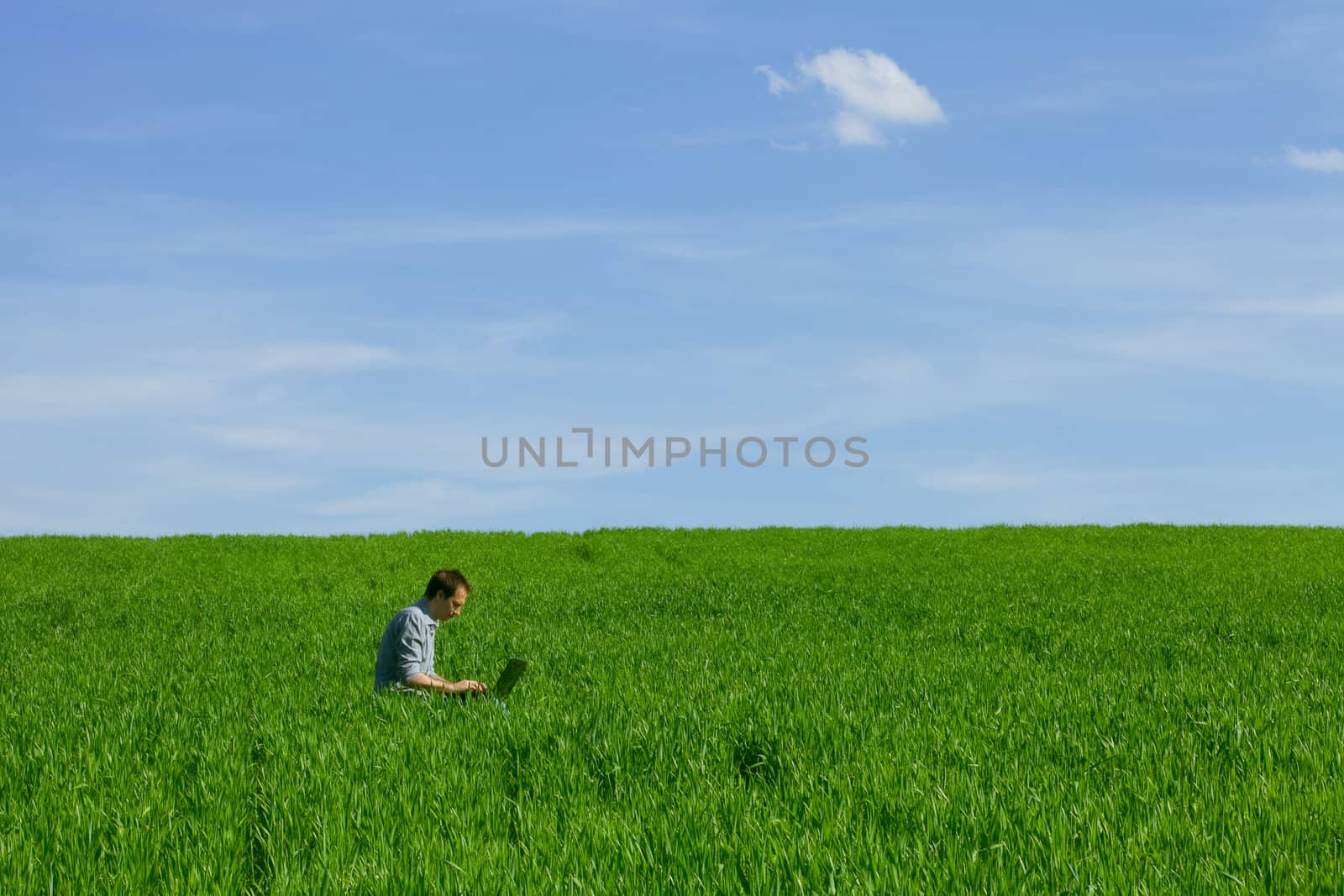 Young man using a laptop outdoors