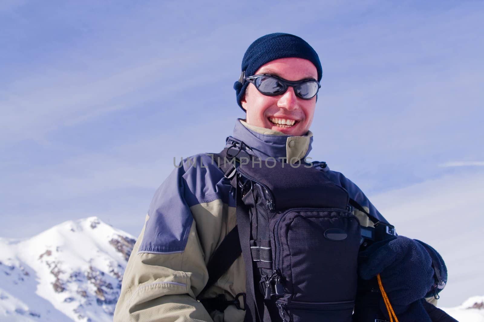 Glad man on background of the mountains.