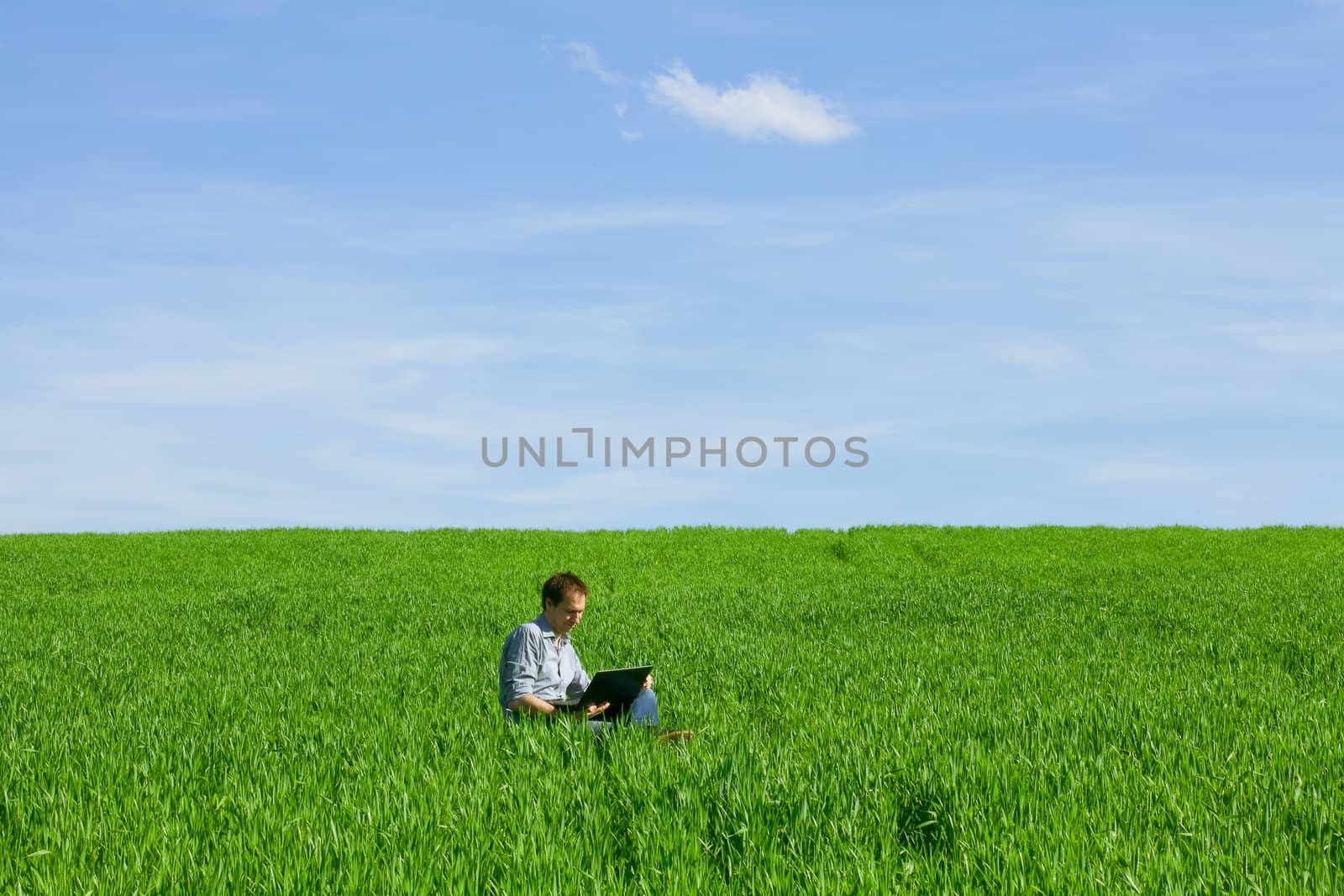 Young man using a laptop outdoors