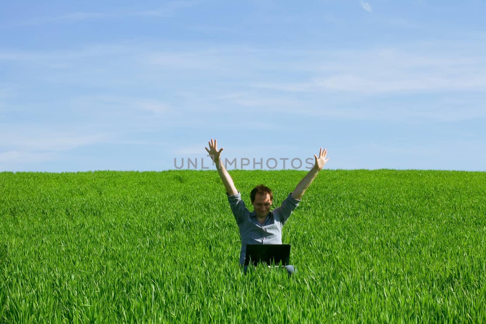 Young man using a laptop outdoors