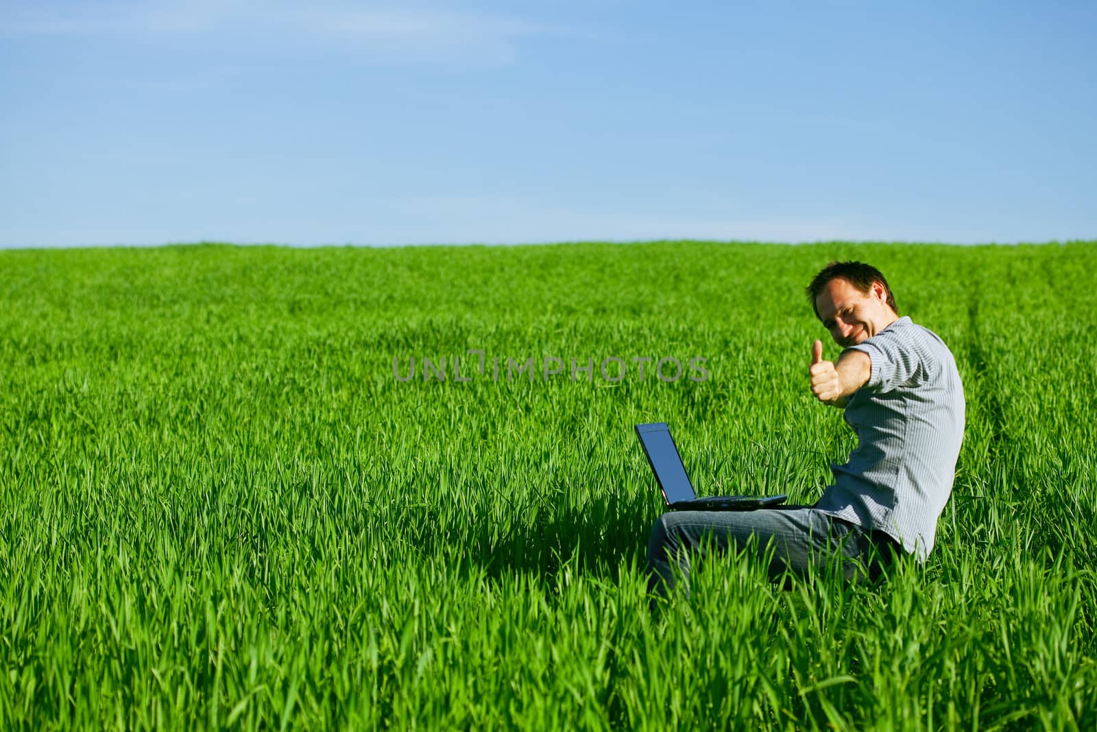 Young man using a laptop outdoors