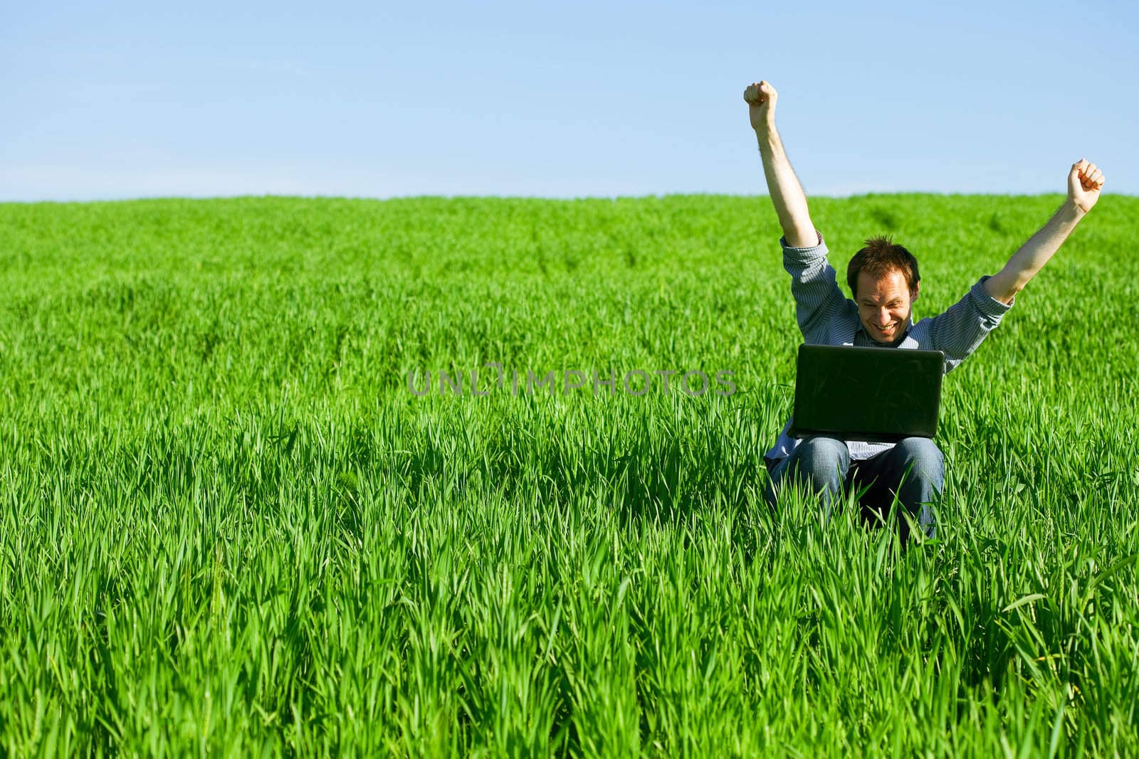 Young man using a laptop outdoors