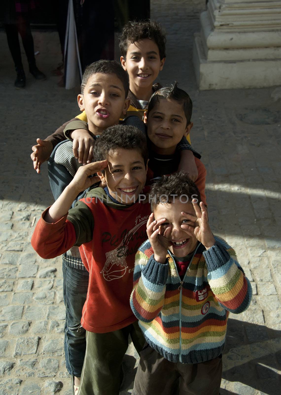 ALEXANDRIA - JAN 27: happy Egyptian boy grimace at photographer in a street in downtown of Alexandria.Jan 27,2013 in Alexandria,Egypt.