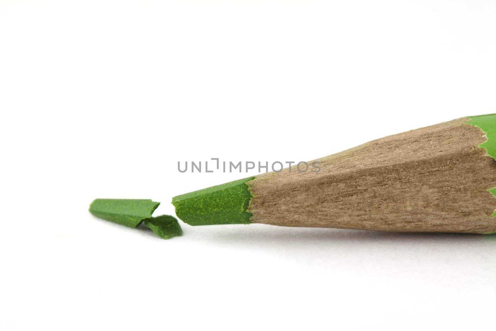 Broken green pencil isolated on white background