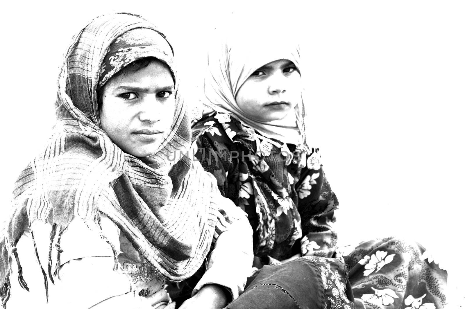 HURGHADA - JAN 30: Bedouin girls look at photographer sat in Sahara desert.Jan 30,2013 in Hurghada,Egypt.
