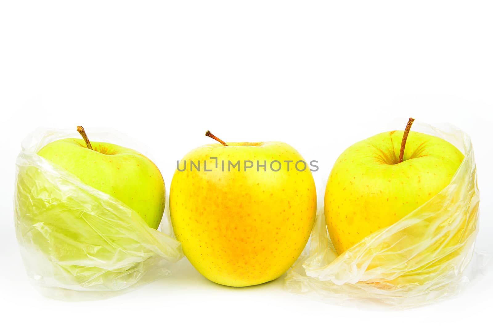 Composition of three unpeeled apples on a white background