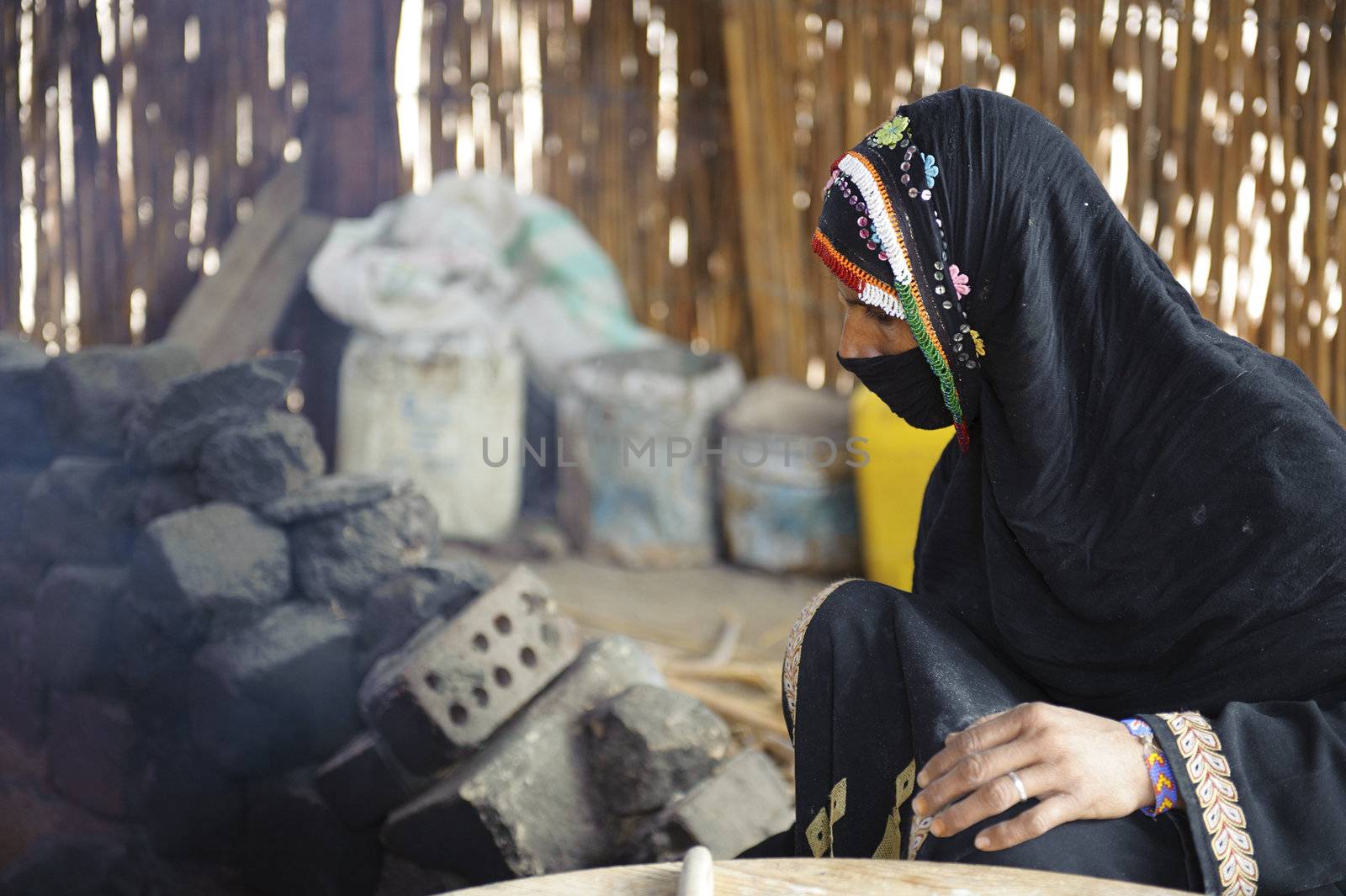 HURGHADA - JAN 30: Veiling Bedouin women is baking Arabic bread.Jan 30,2013 in Hurghada,Egypt.