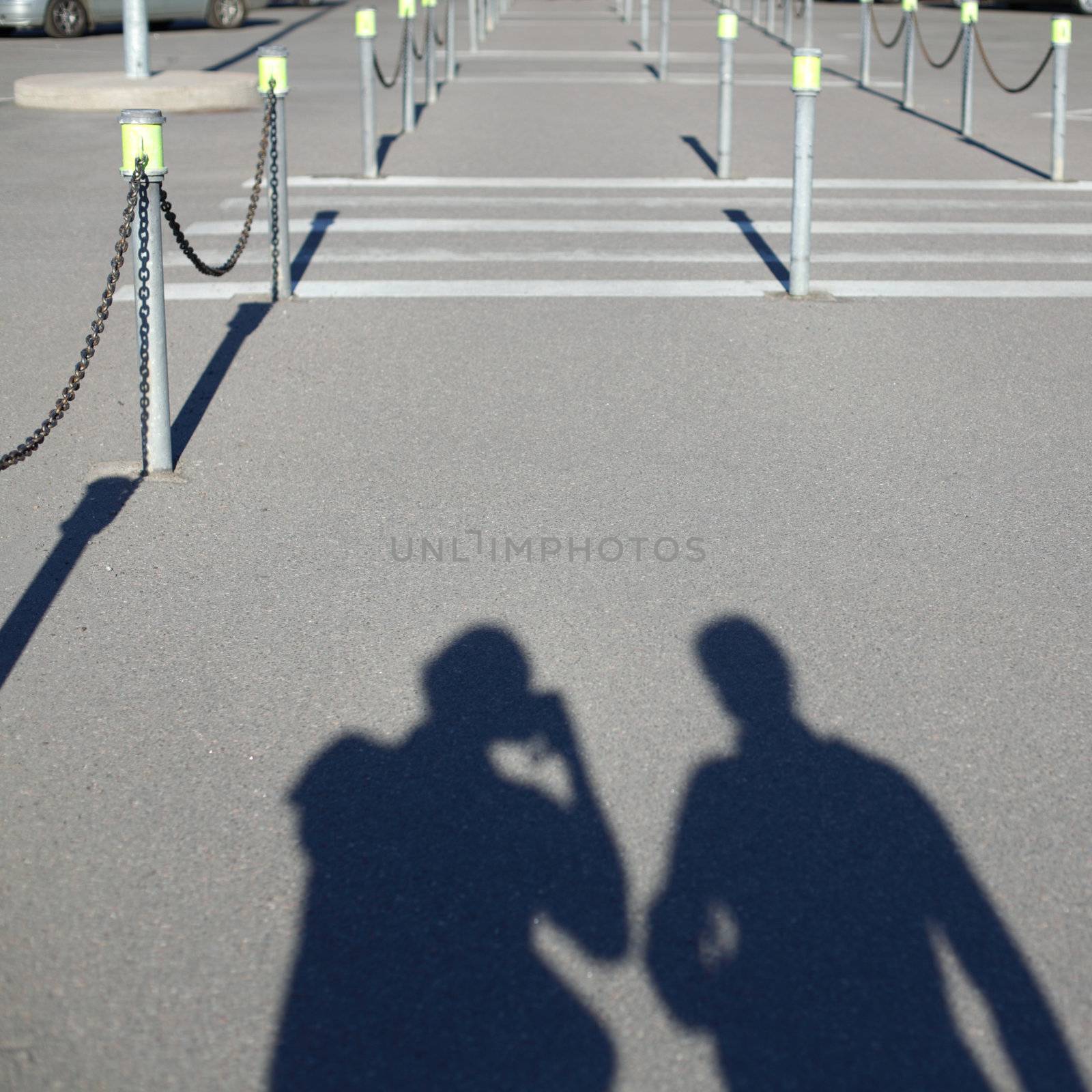  walking peoples silhouettes on asphalt