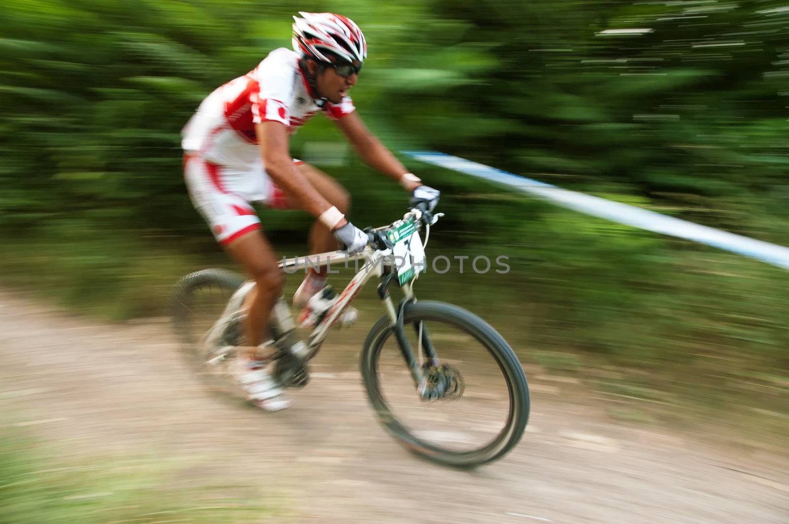 Sportsman's on white bike motion photo by nvelichko