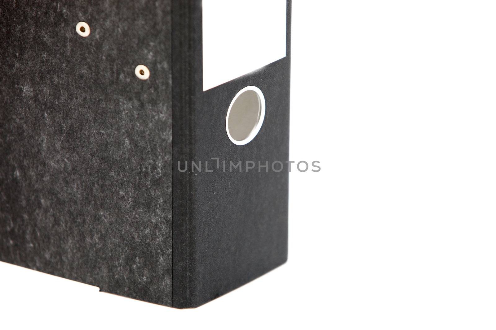 Lower half of a black hardcover office binder showing the metal ring to insert your finger to pull it off the shelf isolated on white