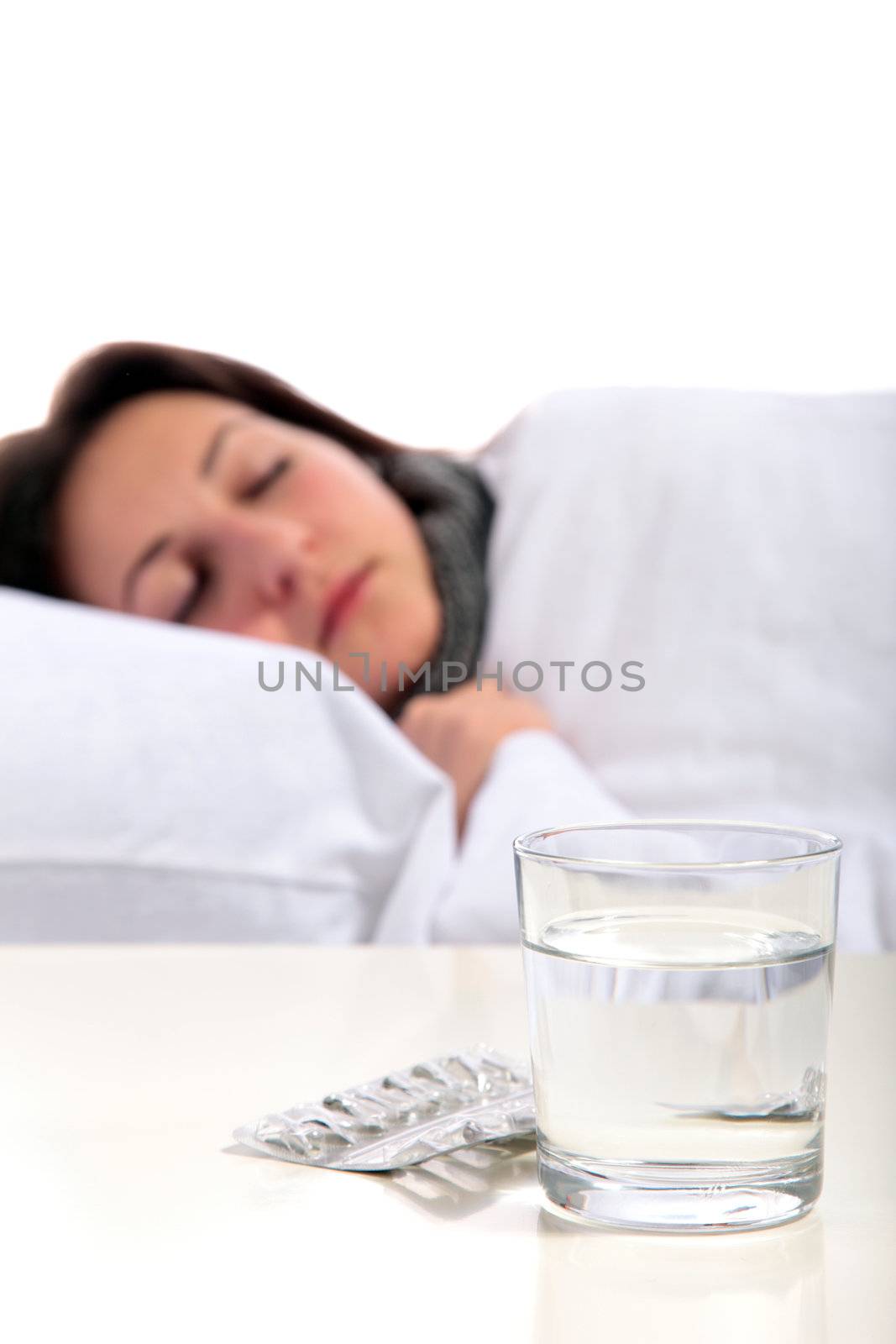 A young ill woman lying in the bed. All on white background.