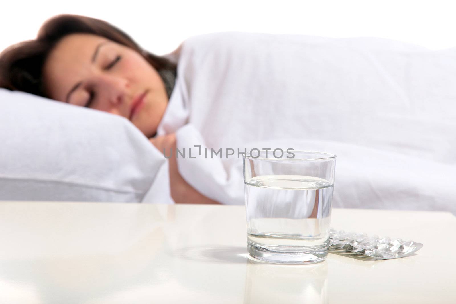 A young woman is sleeping in the bed. All on white background.