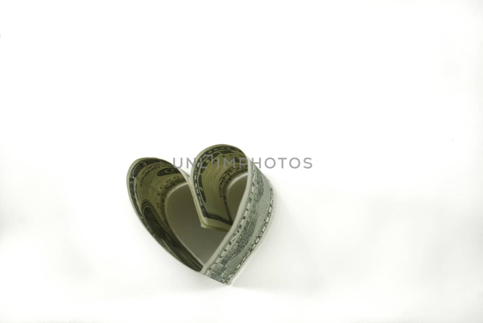 heart shaped 100 dollar bill isolated on white background