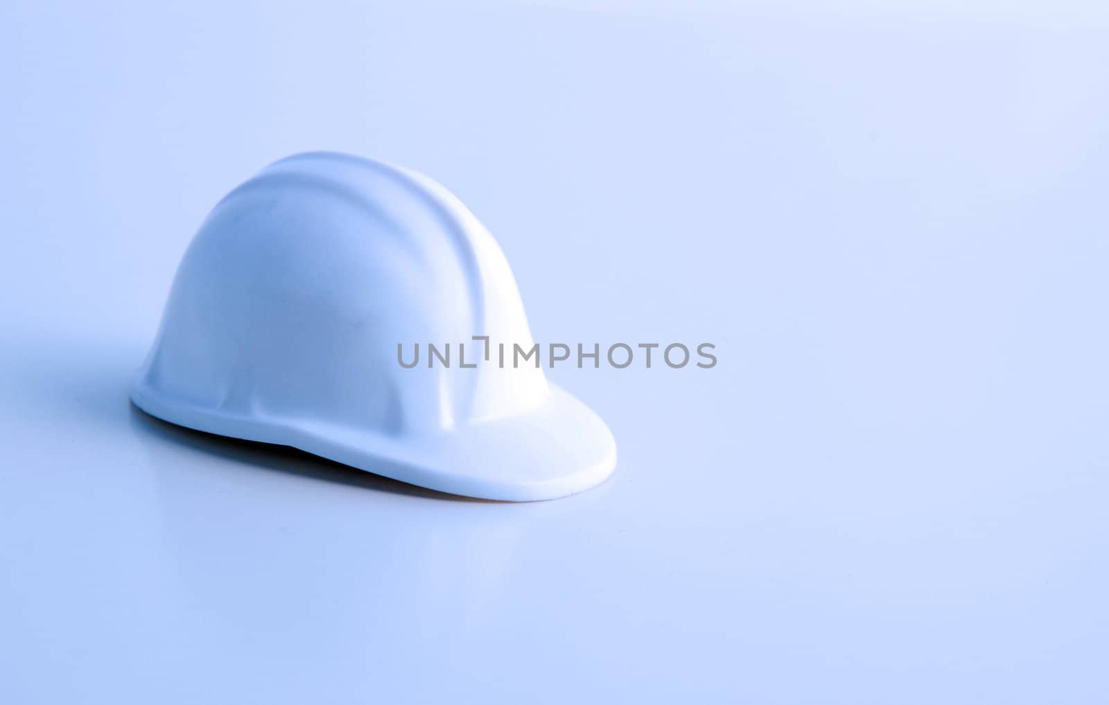 A hard hat lying on a floor.