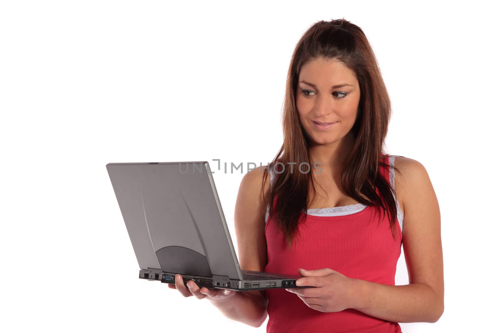 An attractive young woman using a notebook computer. All isolated on white background.