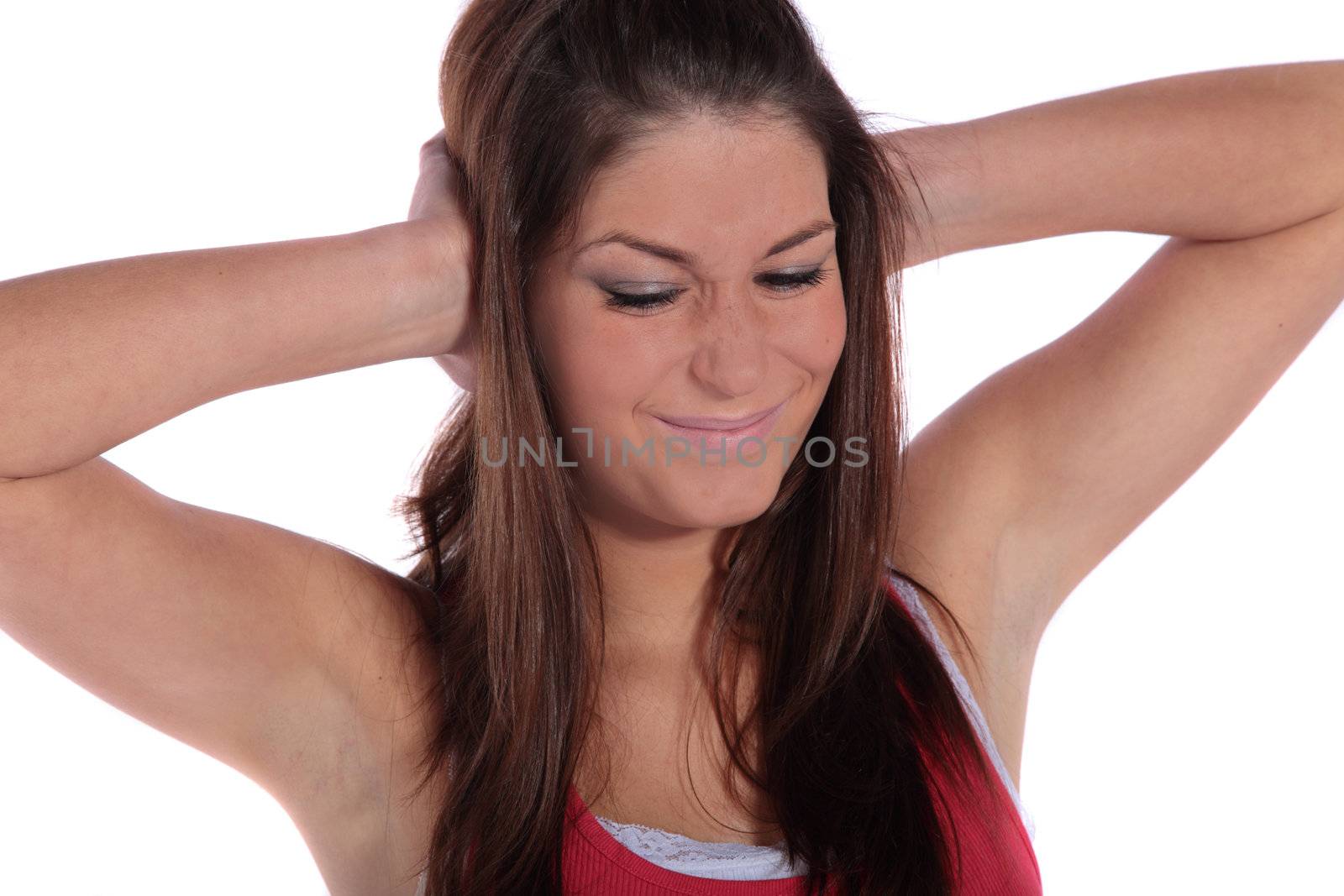 An attractive young woman suffering from a tinnitus. All isolated on white background.