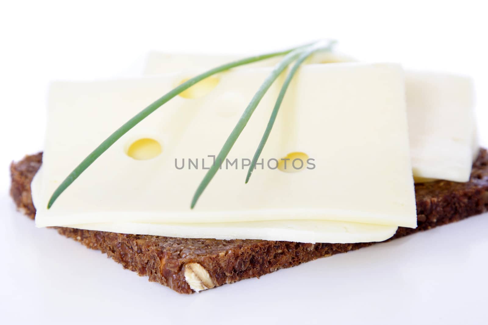 Fine served granary bread with cheese. All on white background.