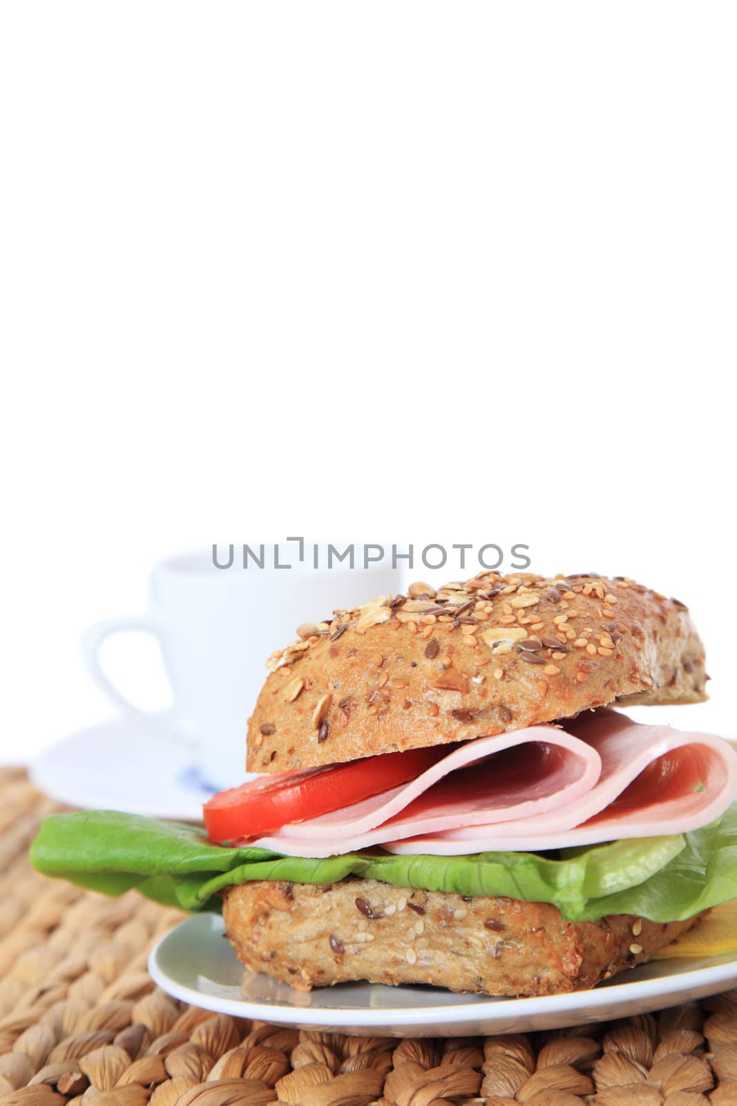 Fine served multi-grain roll with boiled ham. All on white background.