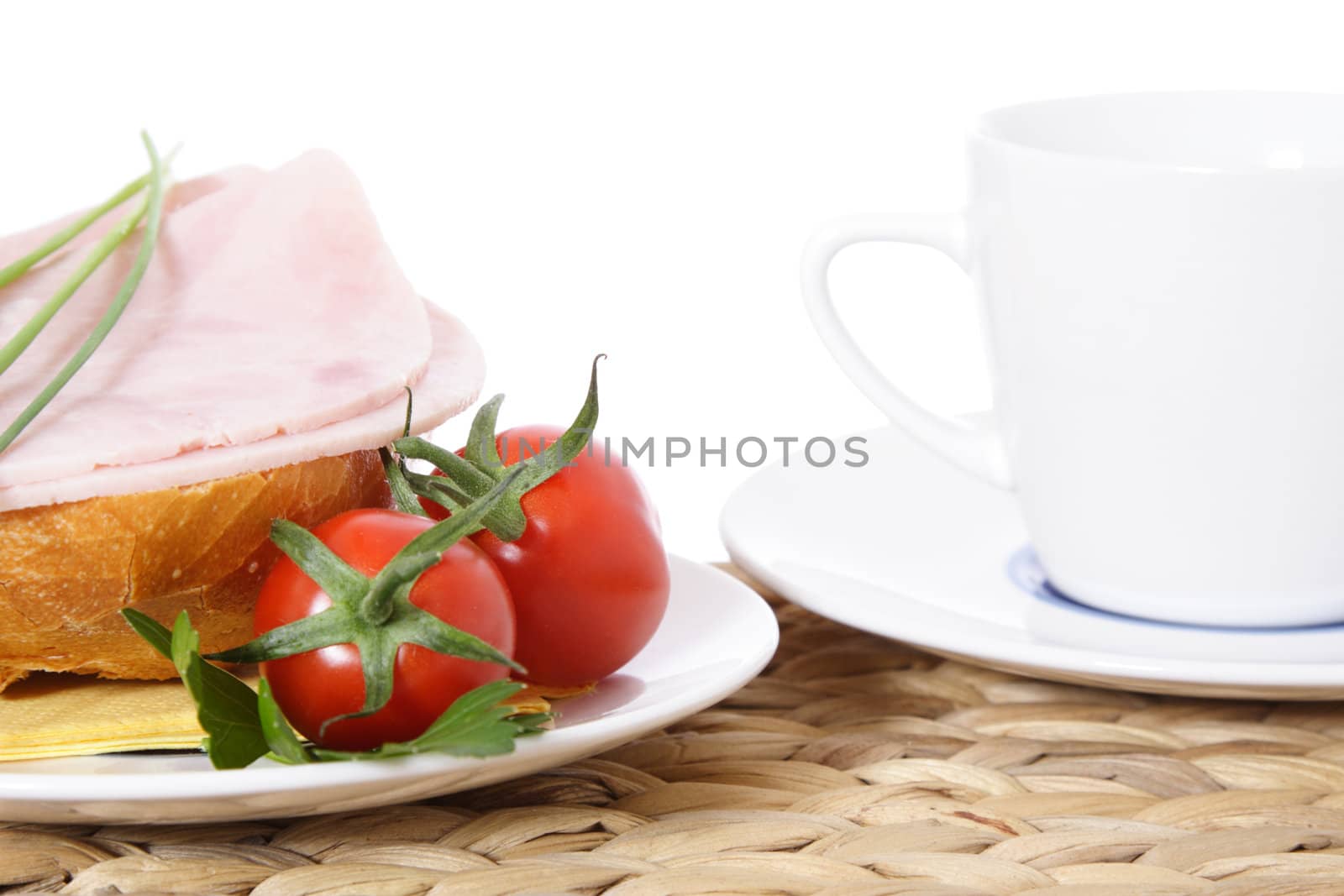 Fine served half wheat roll with boiled ham. All on white background.