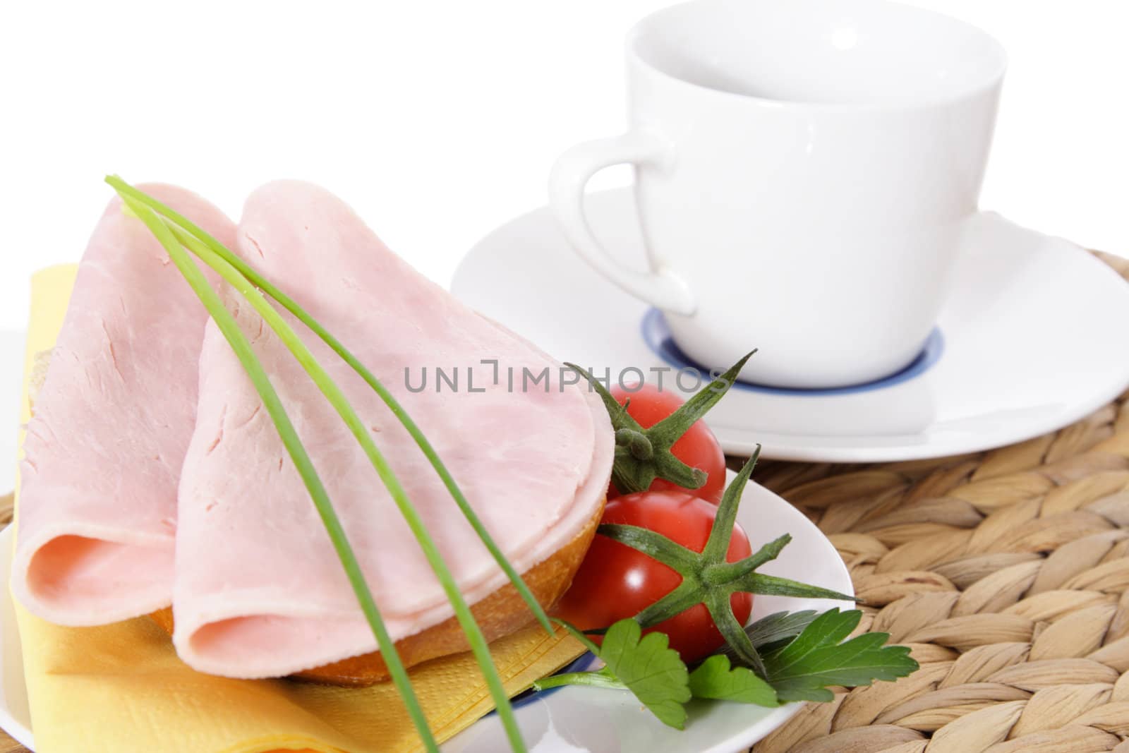 Fine served half wheat roll with boiled ham. All on white background.