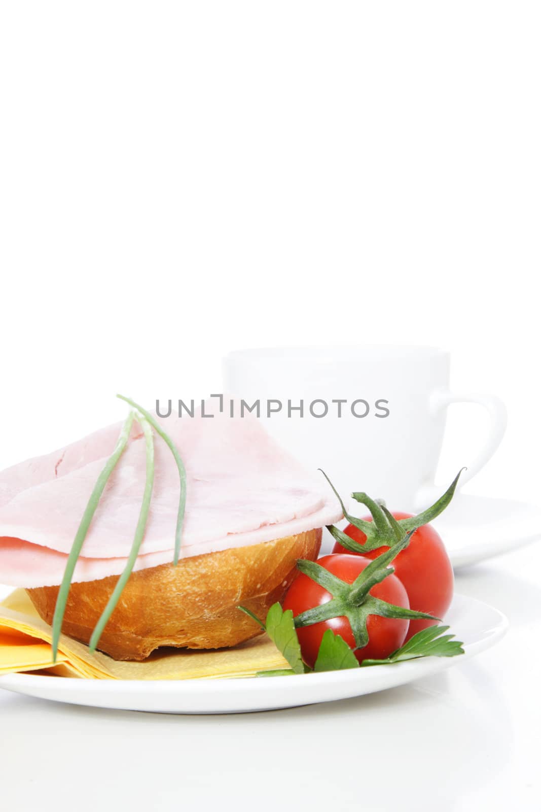 Fine served half wheat roll with boiled ham. All on white background.