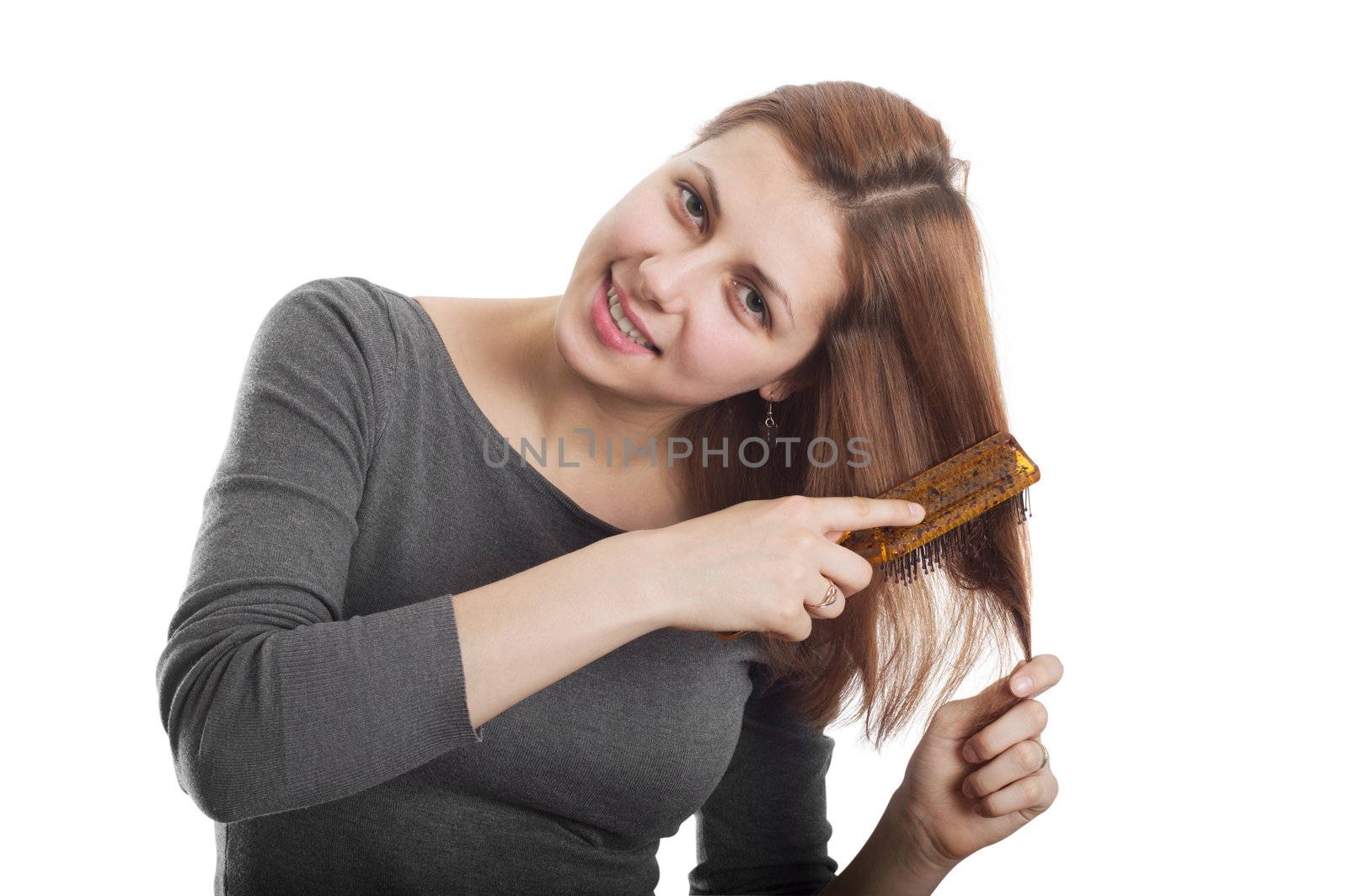 cute girl brushing her hair with his head to the side isolated on white background