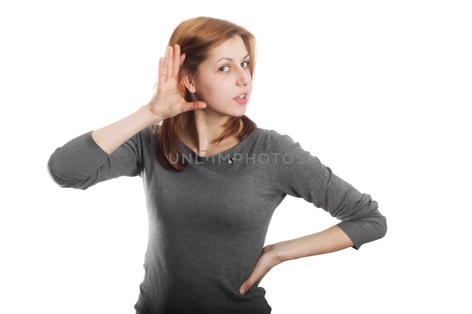 charming girl listens his hand to his ear isolated on white background
