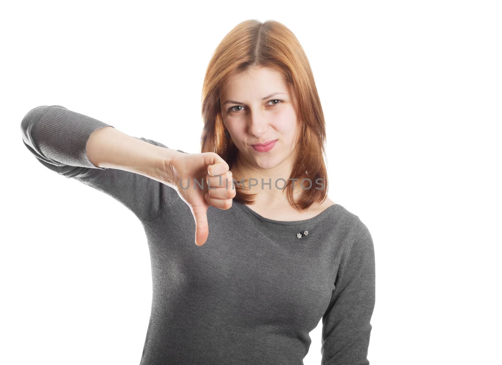 attractive girl with disdain on his face, pointed their thumbs down on a white background isolated