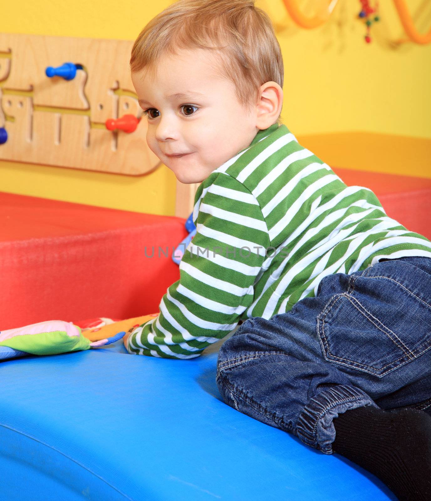 Cute caucasian toddler having fun in kindergarten.