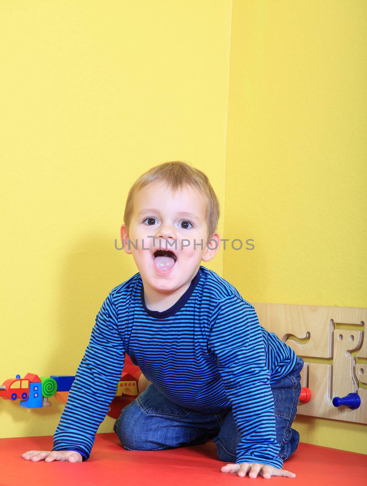 Cute caucasian toddler having fun in kindergarten.