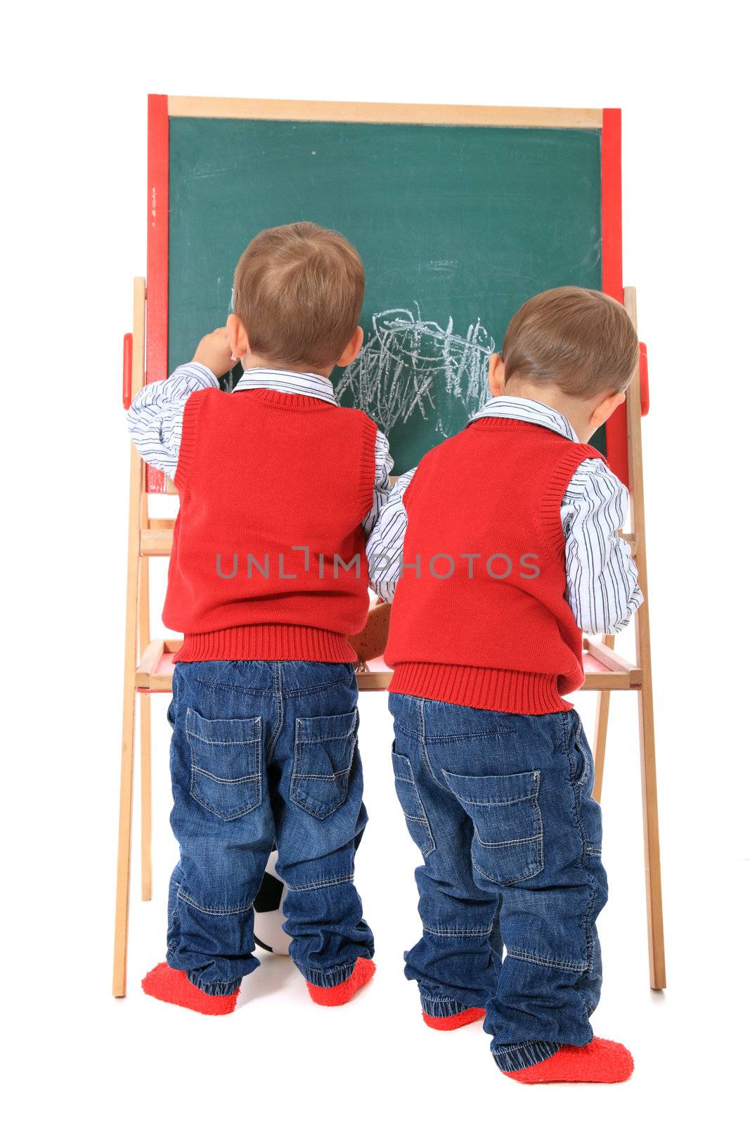 Two cute caucasian twin brothers playing with chalkboard. All isolated on white background.