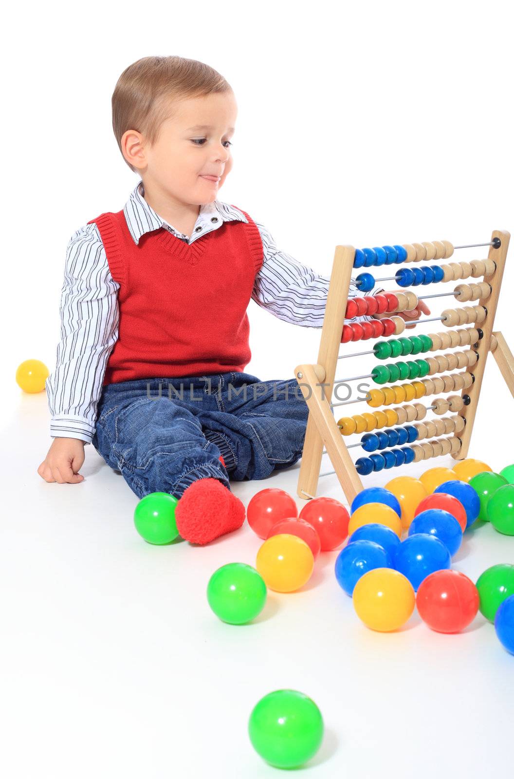 Cute caucasian toddler playing with sliderule. All isolated on white background. Foreground in very light grey.