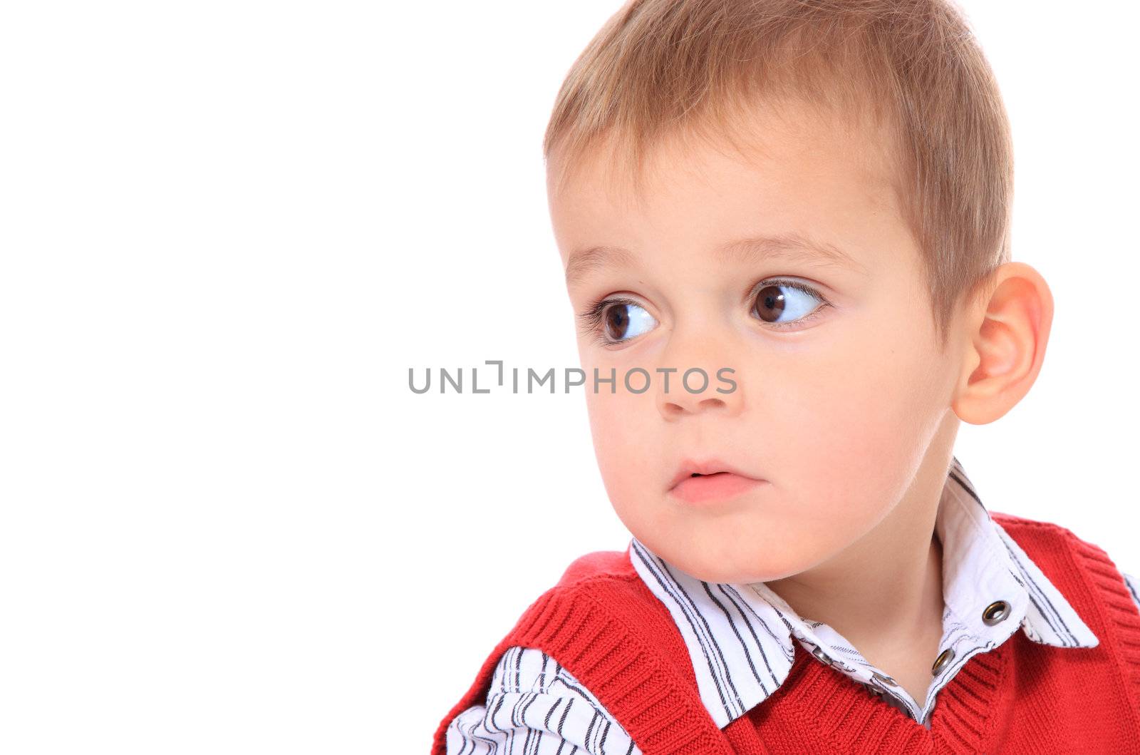 Cute caucasian toddler looking to the side. All isolated on white background. Extra copy space on left side