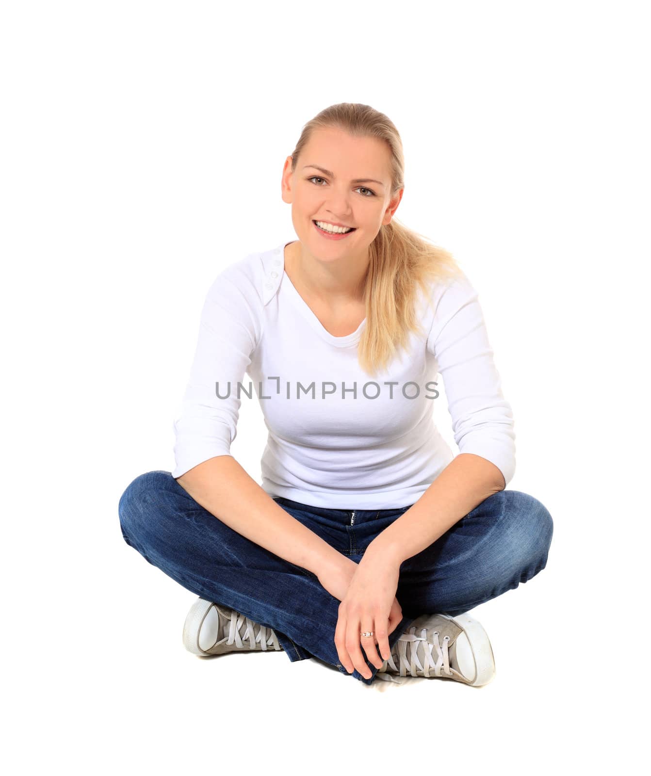 Attractive blond woman sitting on the floor. All on white background.