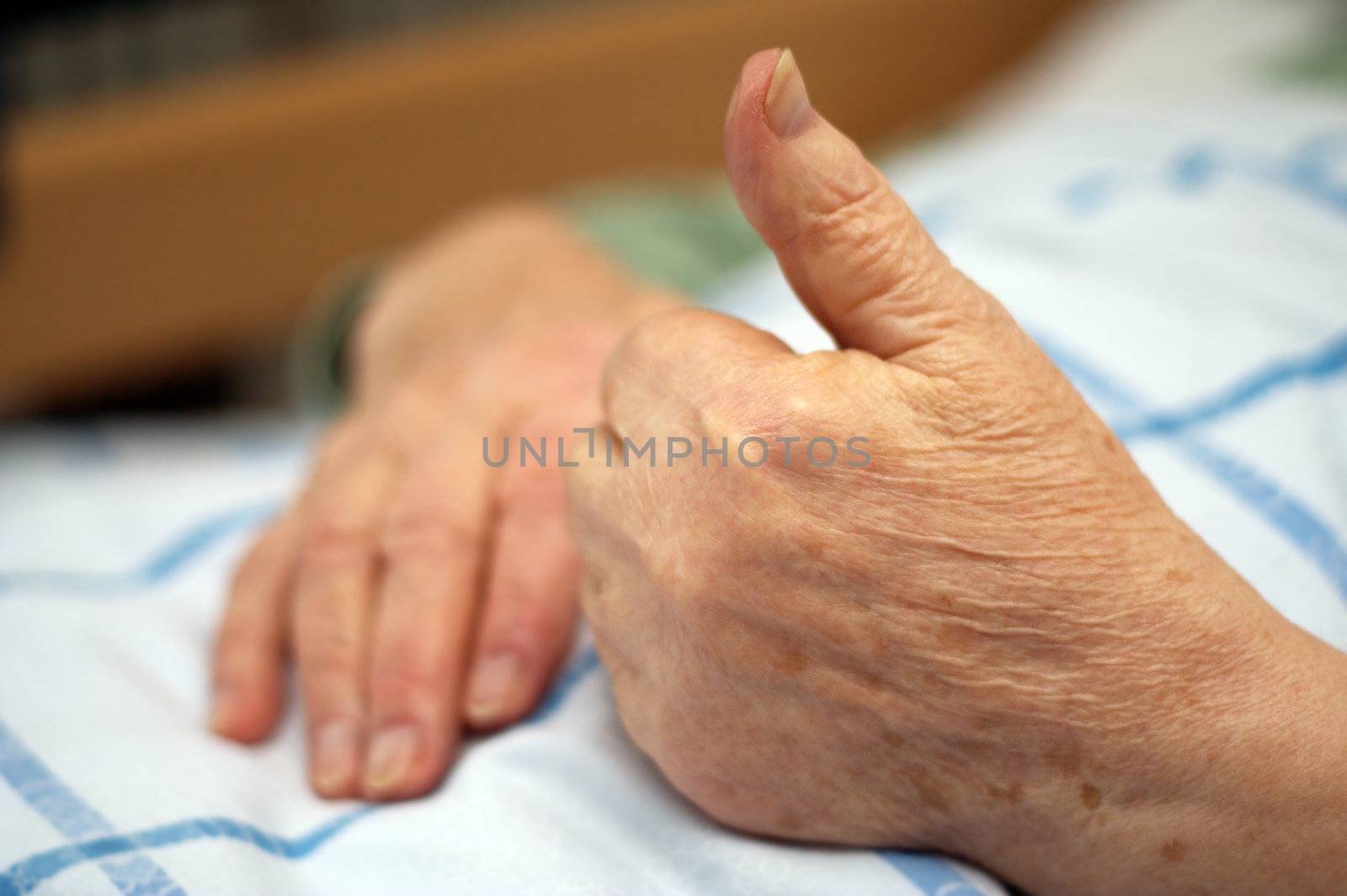 Care-dependent person showing thumbs up.