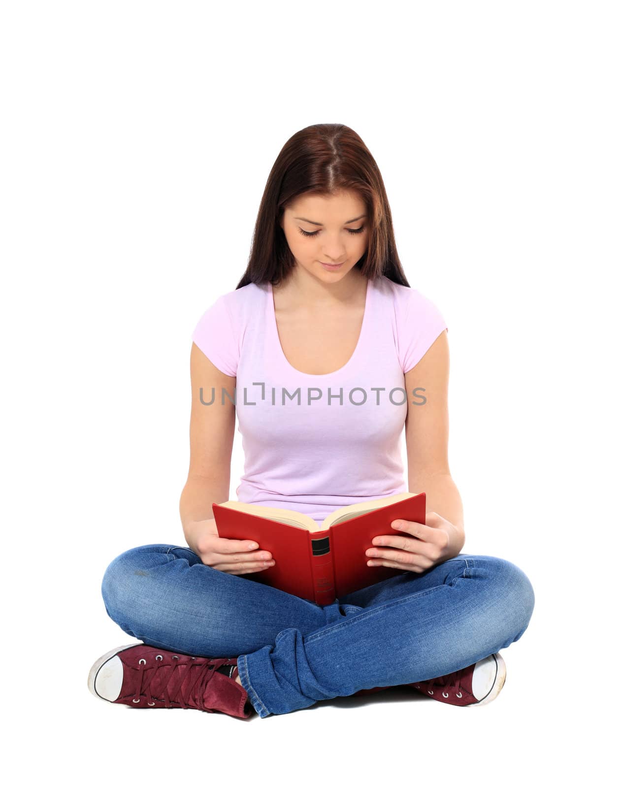 Attractive teenage girl reading a book. All on white background.