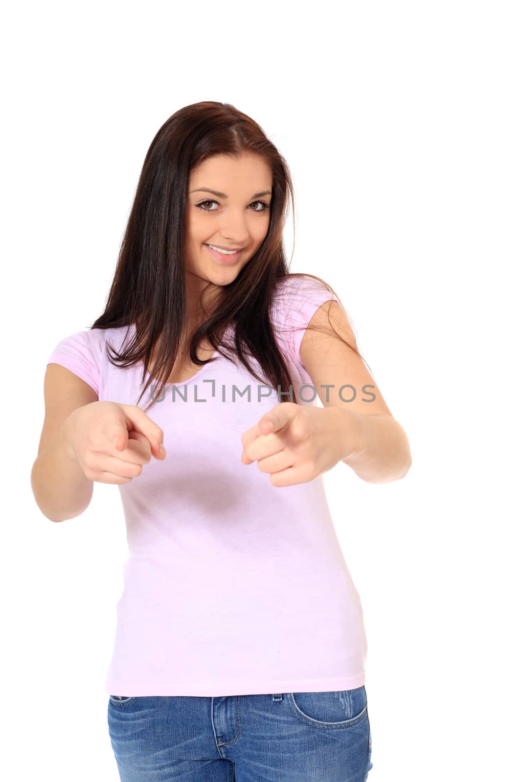 Attractive teenage girl pointing with finger. All on white background.