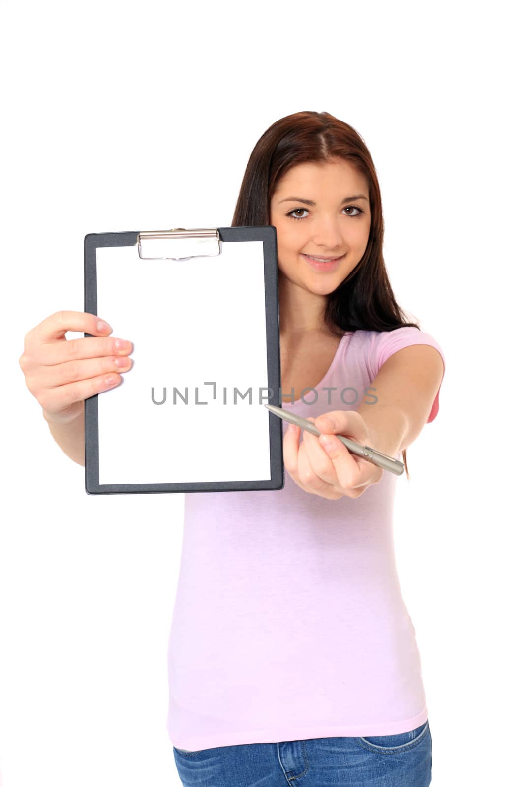 Attractive teenage girl pointing at clipboard. All on white background.