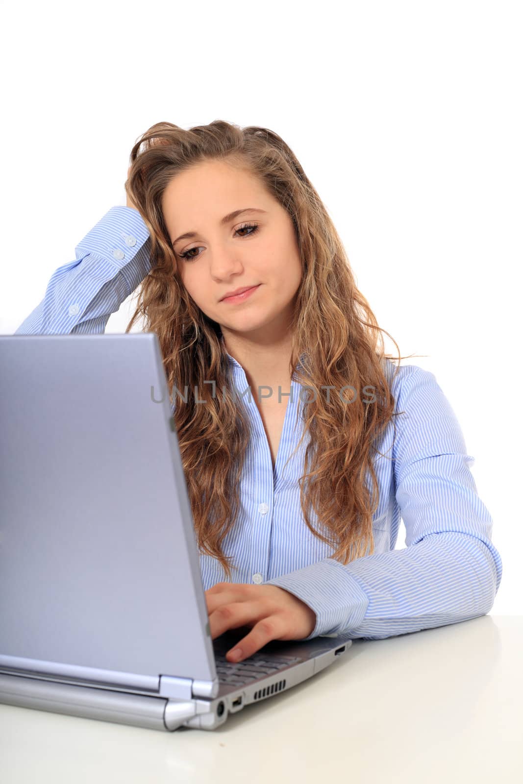 Portrait of an attractive young girl being frustrated because of her notebook computer. All on white background.