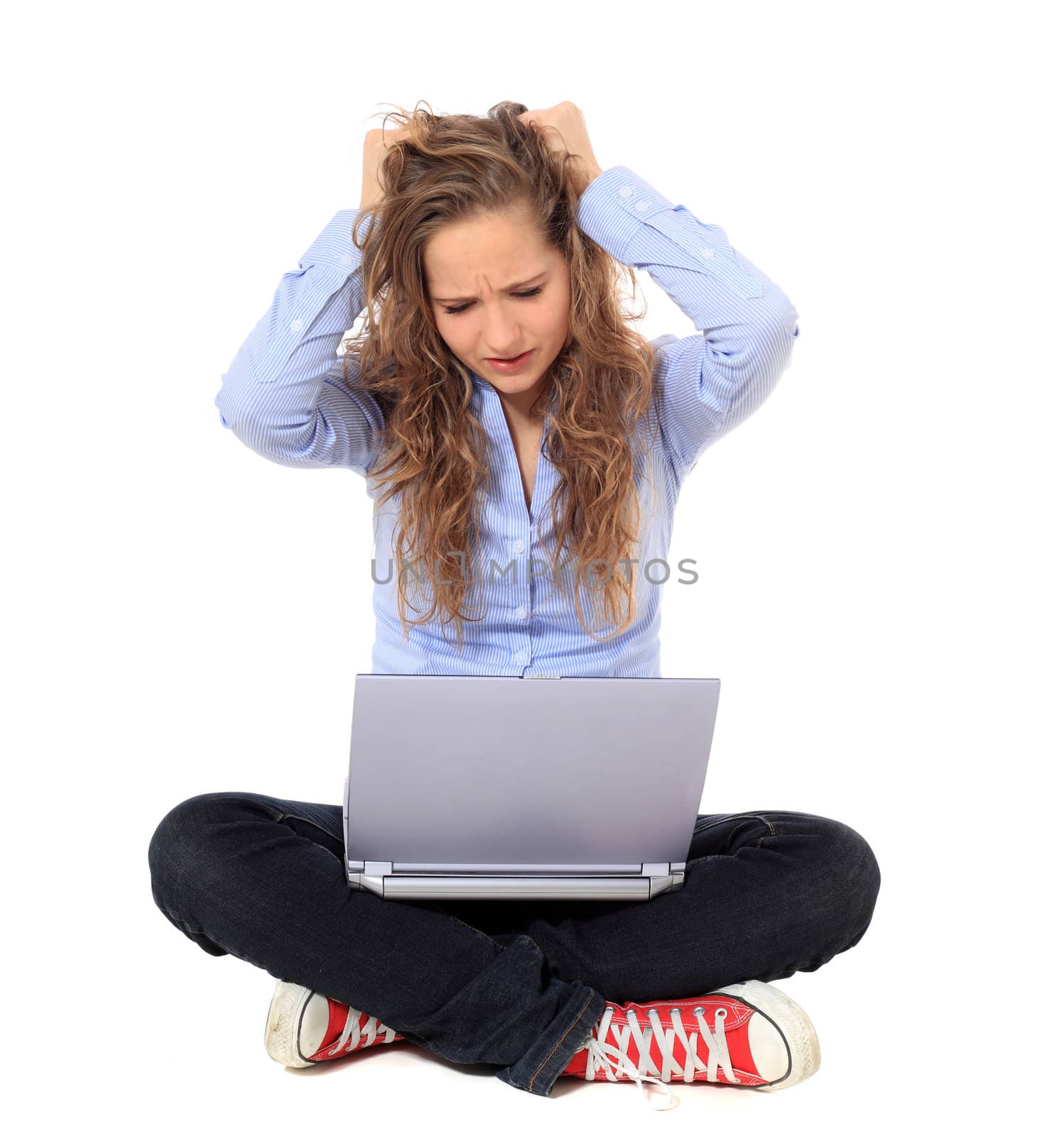 Frustrated young girl using notebook computer. All on white background.