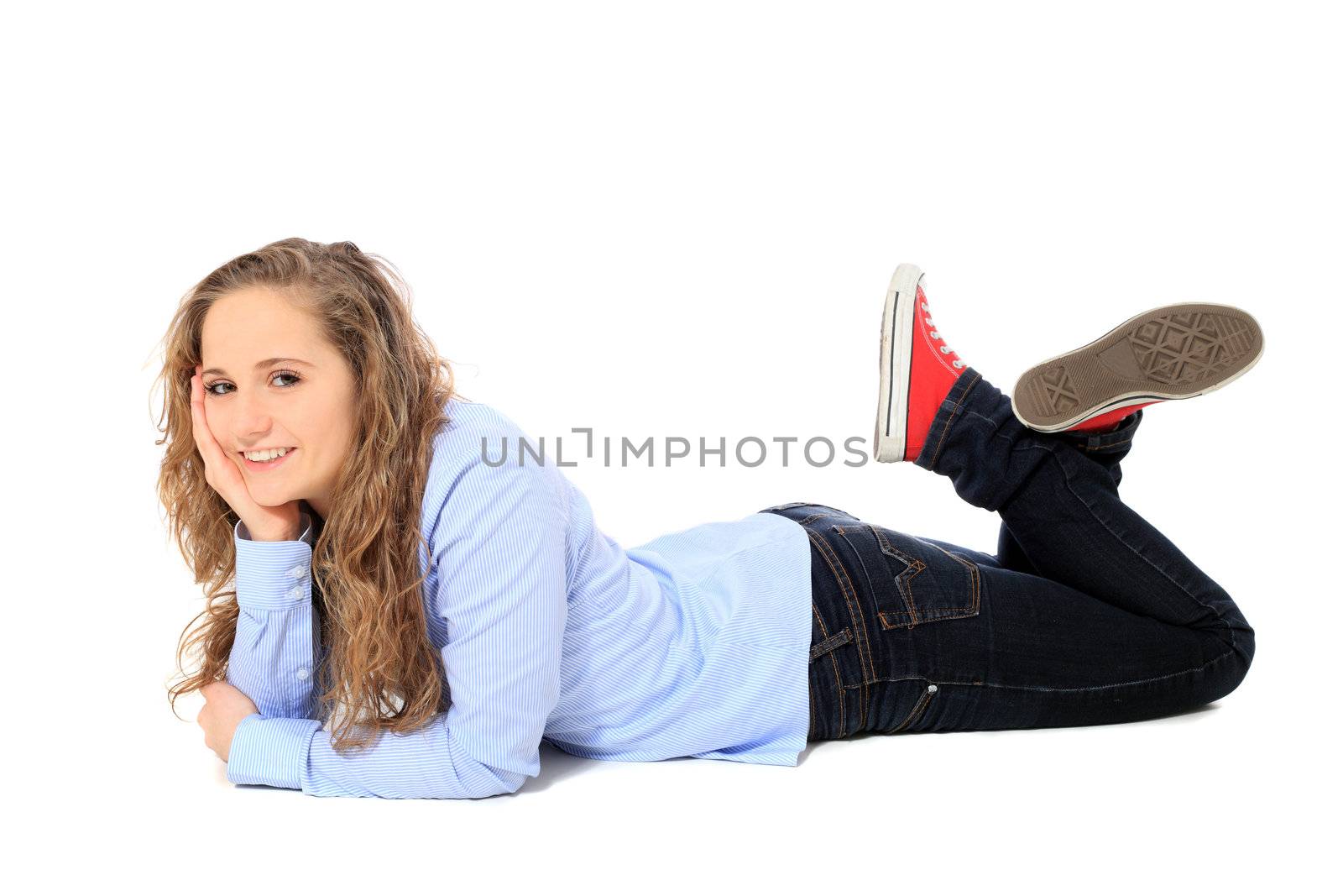 Attractive young girl lying on the floor. All on white background.