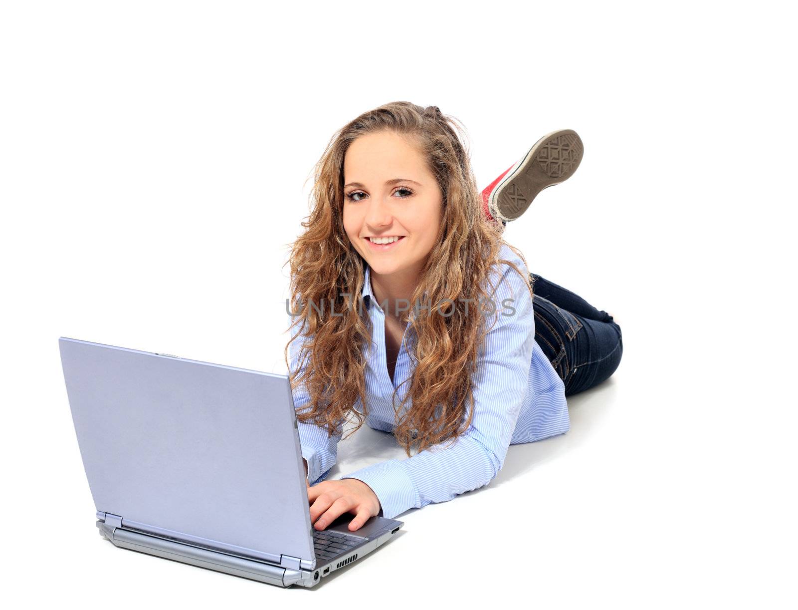 Attractive young girl using notebook computer. All on white background.