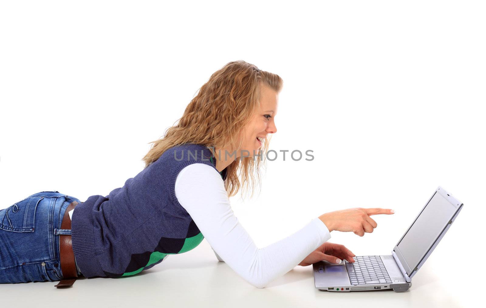 Attractive young woman lying on floor using notebook computer. All on white background.