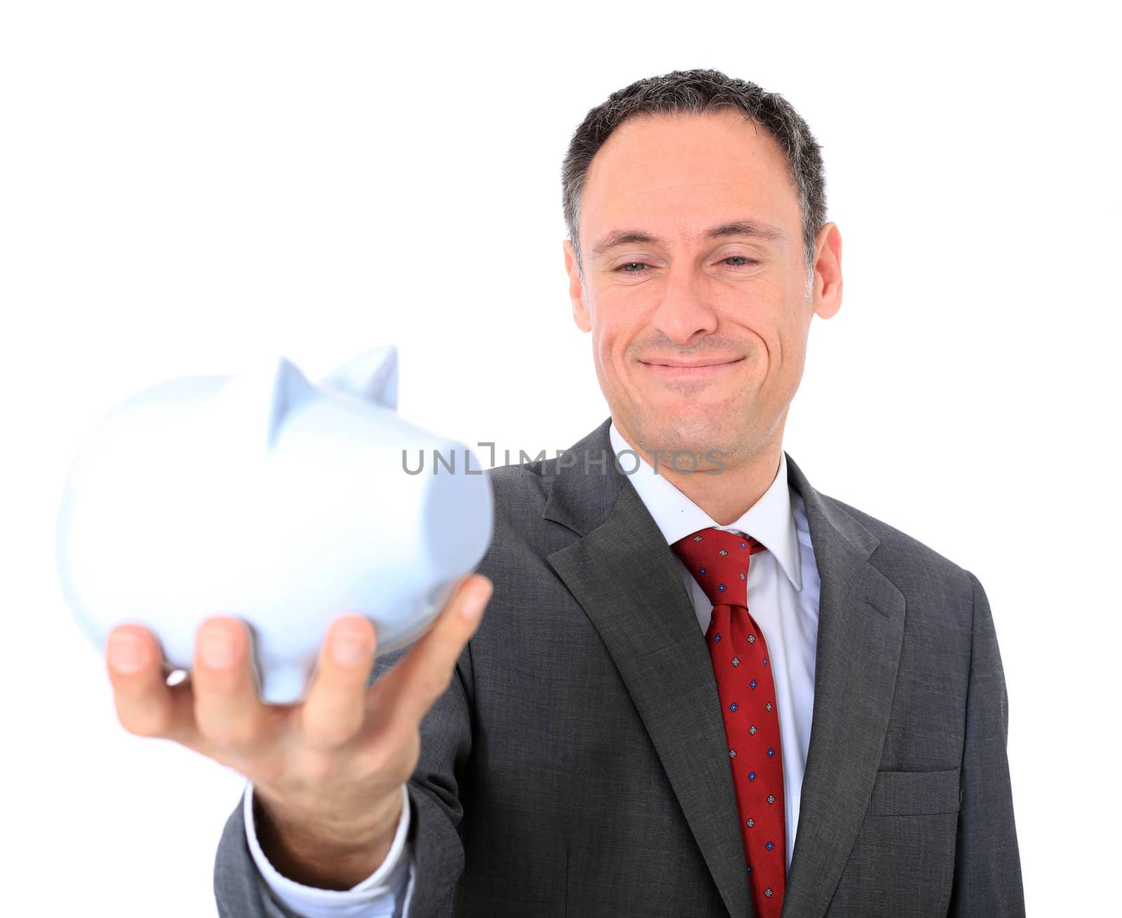 Attractive businessman holding piggy bank. All on white background.