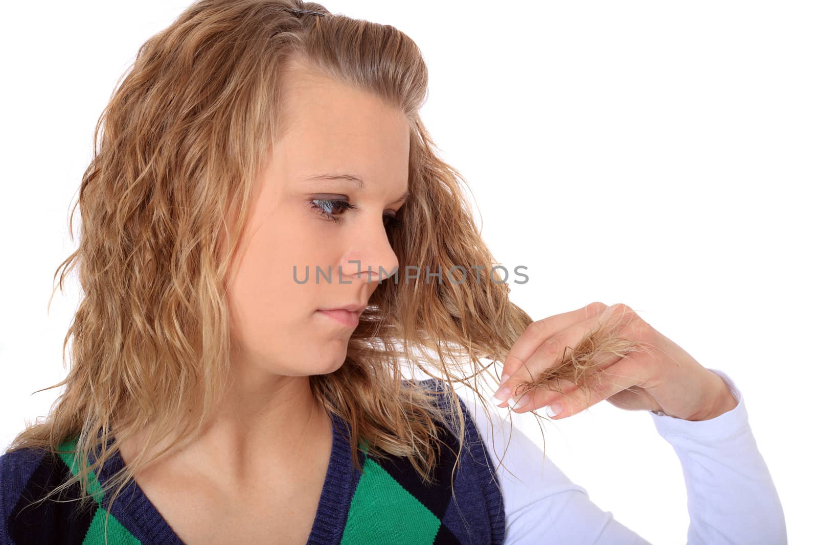 Attractive woman checking her hair. All on white background.