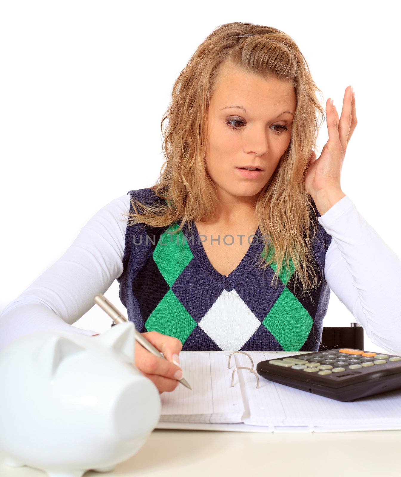 Attractive woman is shocked while doing her budgeting. All on white background.