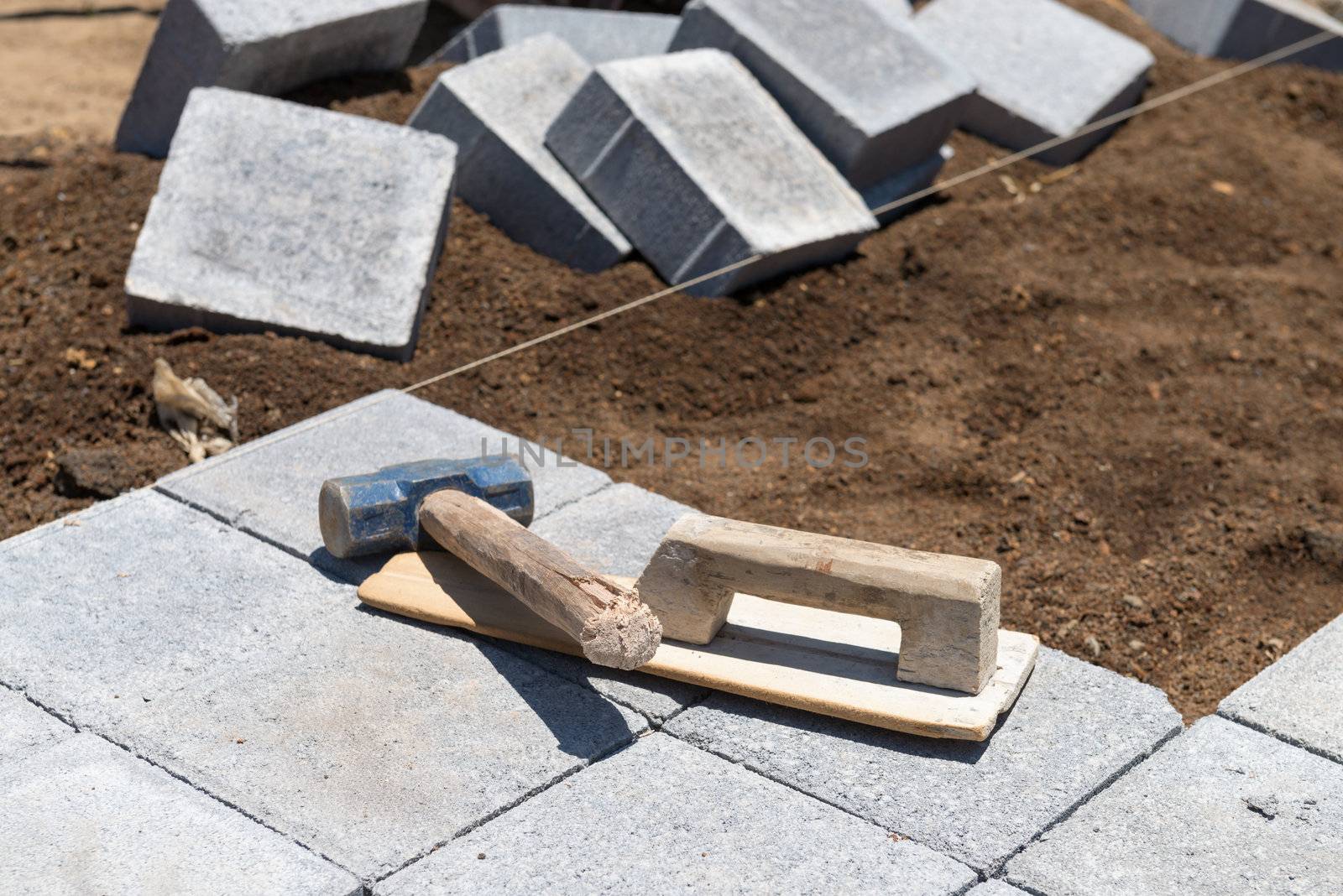 Paving grey blocks with instruments in working process