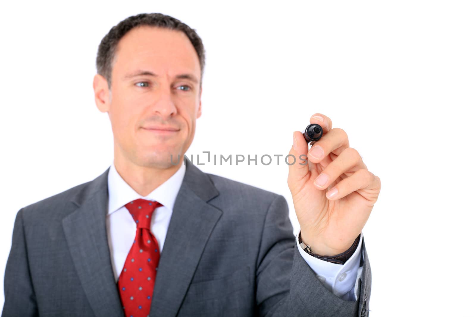 Attractive businessman using marker. Focus on hand ind foreground. All on white background.