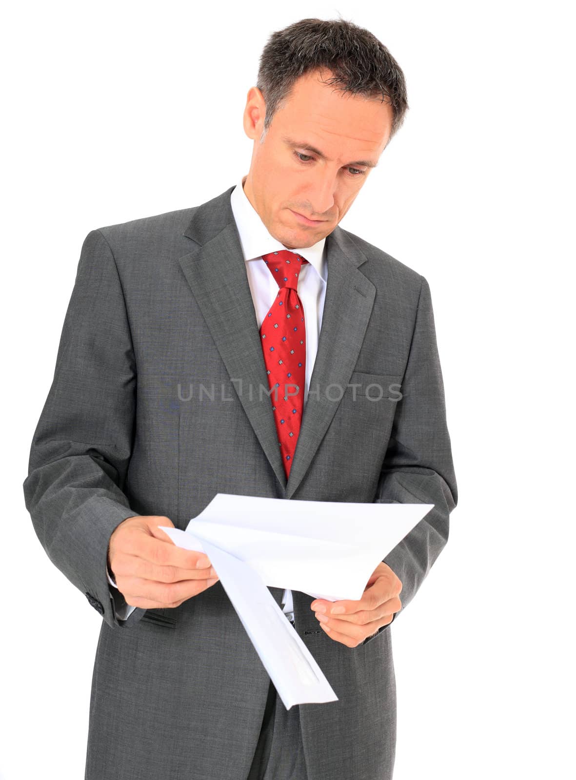 Attractive businessman reading a letter. All on white background.