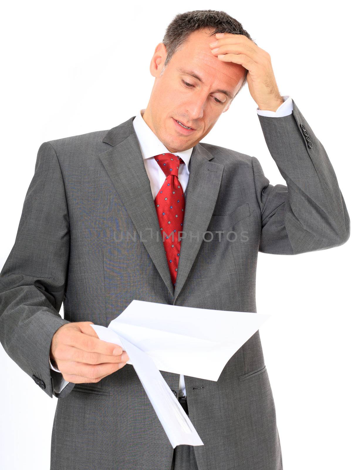 Attractive businessman gets bad news. All on white background.